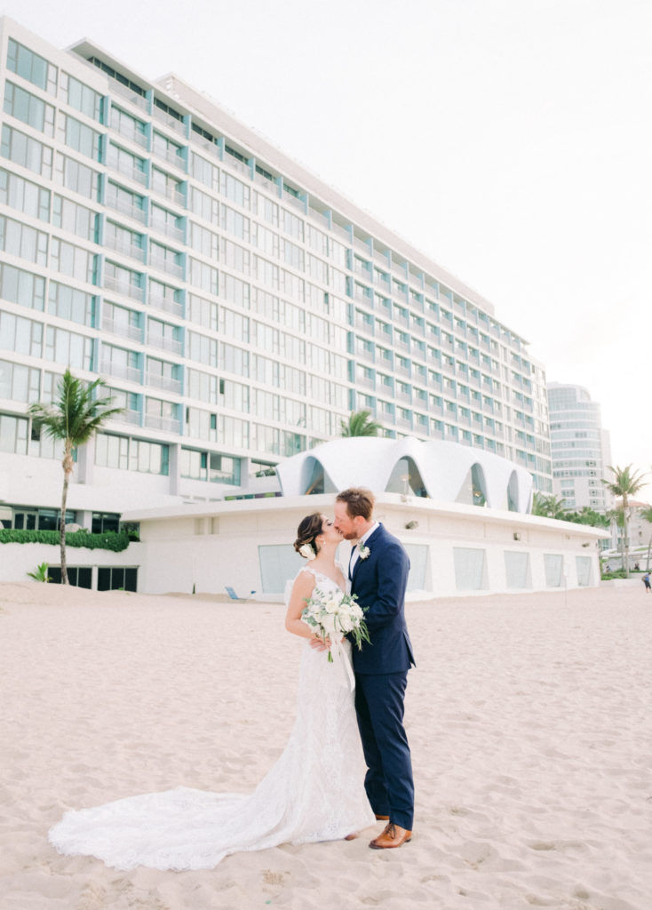couple kissing at the beach perla in la concha weddings in puerto rico