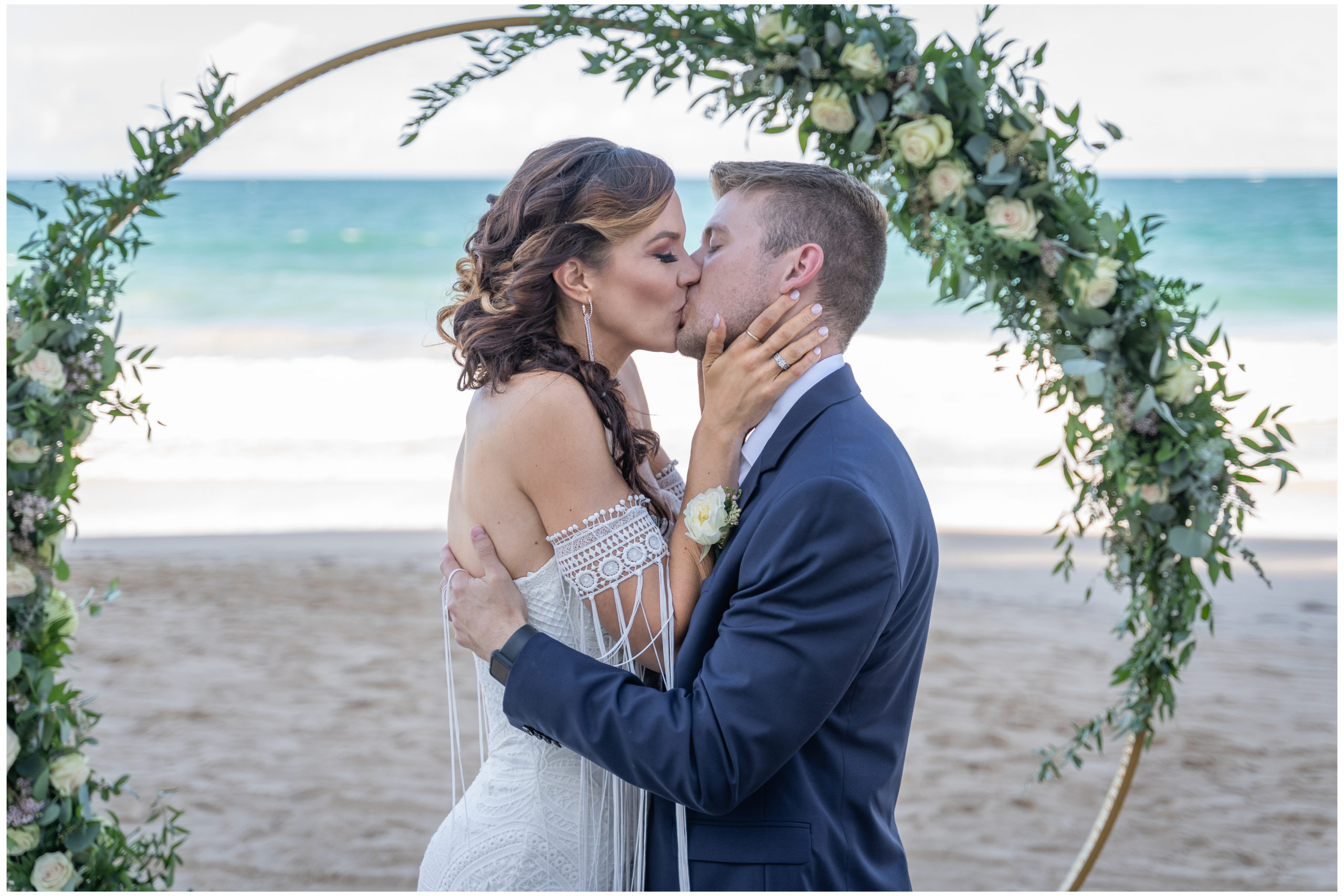 couple kissing beach front at la concha wedding in puerto rico