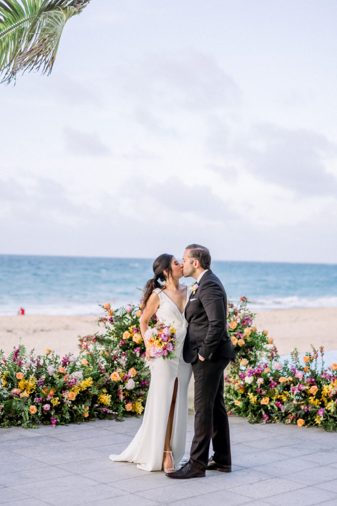 wedding couple kissing in the beach at la concha
